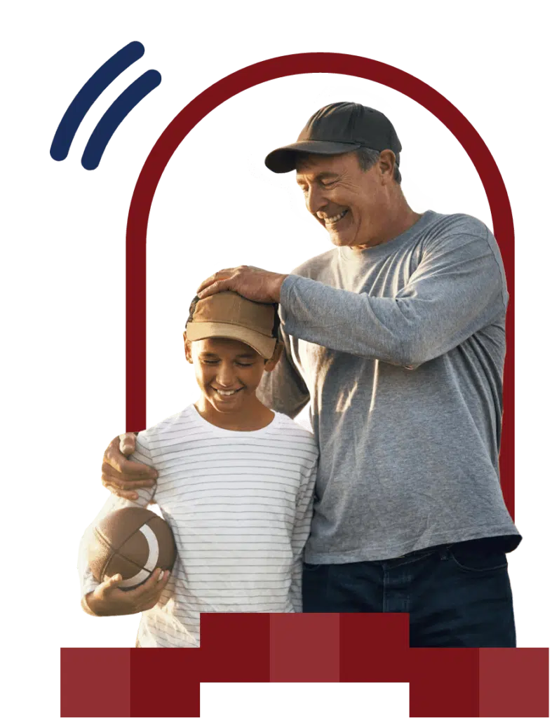 father and son playing football outdoors in NY