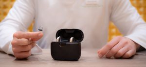 Audiologist-presenting-different-types-of-hearing-aids-to-a-patient